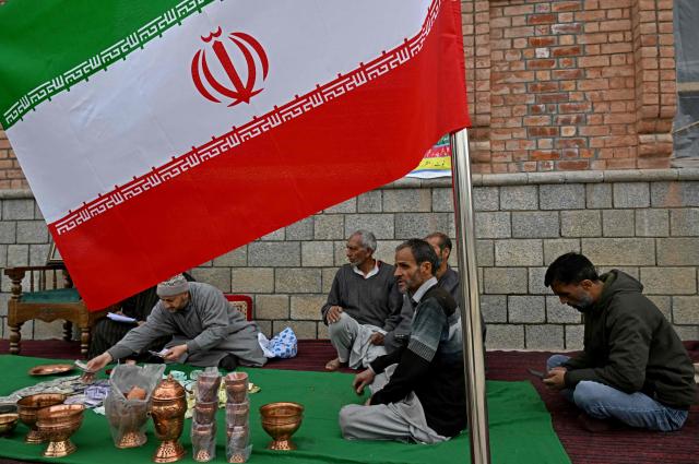 Kashmiri Muslims conduct a donation drive for war-stricken Iran, collecting cash, gold, and other contributions amid the Middle East conflict, on the outskirts of Srinagar on March 23, 2026. (Photo by Tauseef MUSTAFA / AFP)