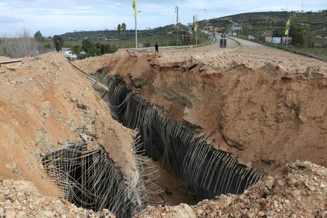 A photograph taken on March 23, 2026 shows the aftermath of the Israeli airstrike that targeted the Qasmiyeh bridge, located on a main highway linking villages in the Tyre district with others further north, after Israel said the bridge was being used by Hezbollah, in southern Lebanon. The Lebanese president on March 22, 2026, slammed Israeli strikes on bridges and other infrastructure in the country's south, calling such attacks a "prelude to a ground invasion". Lebanon was drawn into the Middle East war on March 2, when pro-Iran Hezbollah launched rockets towards Israel in response to US-Israeli strikes that killed Iranian supreme leader on February 28, 2026. (Photo by Kawnat HAJU / AFP) / 
