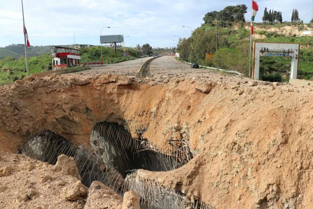 A photograph taken on March 23, 2026 shows the aftermath of the Israeli airstrike that targeted the Qasmiyeh bridge, located on a main highway linking villages in the Tyre district with others further north, after Israel said the bridge was being used by Hezbollah, in southern Lebanon. The Lebanese president on March 22, 2026, slammed Israeli strikes on bridges and other infrastructure in the country's south, calling such attacks a "prelude to a ground invasion". Lebanon was drawn into the Middle East war on March 2, when pro-Iran Hezbollah launched rockets towards Israel in response to US-Israeli strikes that killed Iranian supreme leader on February 28, 2026. (Photo by Kawnat HAJU / AFP) / 