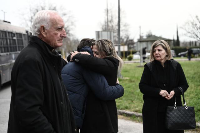 Victims' relatives comfort each other as they arrive at the "Gaipolis" conference venue at the University campus in Larissa to attend the opening hearing of the trial over the deadly Tempi train crash, which killed 57 people in the worst rail accident in Greek history, on March 23, 2026. The case is moving to trial more than three years after the fatal night of February 28, 2023 when two trains collided head-on, to investigate the responsibility for the worst railroad accident in Greece's history. (Photo by Sakis Mitrolidis / AFP)