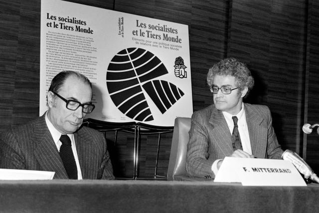 (FILES) French national secretary Lionel Jospin (R) and the first secretary of the Socialist Party (PS) Francois Mitterrand (L) attend a meeting on relations between Socialists and the Third World, on February 14, 1977, in Paris. Former socialist Prime Minister Lionel Jospin has died at the age of 88, his family announced on March 23, 2026. (Photo by AFP)