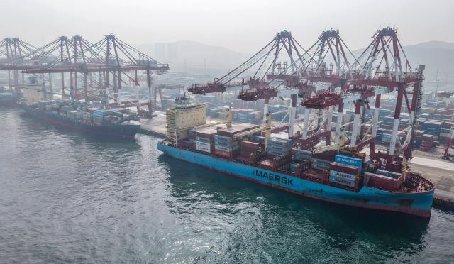 Cargo ships are seen at the container terminal at the port in Qingdao, in China’s eastern Shandong province on March 23, 2026. (Photo by CN-STR / AFP) / China OUT