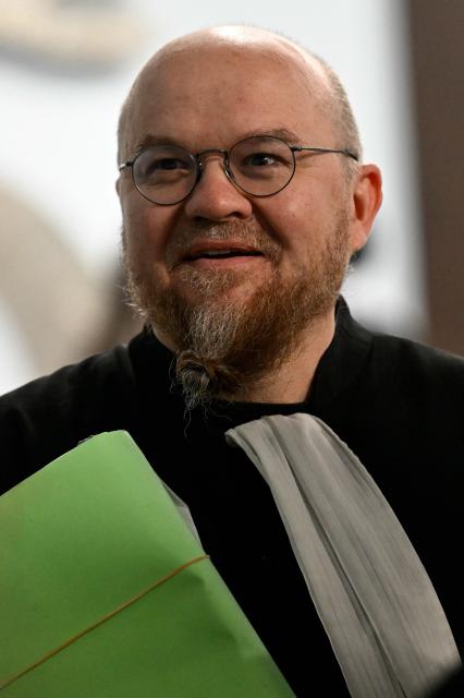 Lawyer Francois Zind, representing environmental associations France Nature Environnement, Lorraine Nature Environnement, Vosges Nature Environnement and Robins des Bois is pictured ahead of the opening hearing of the Nestle Waters trial over the maintenance of four illegal waste dumps in the Vosges department at the judicial complex in Nancy on March 23, 2026. (Photo by Jean-Christophe VERHAEGEN / AFP)