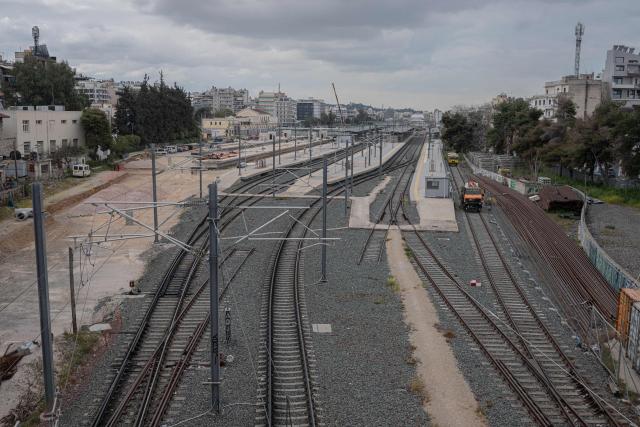 This photo shows the empty railway tracks at the main train station in Athens during a 24-hour general strike on March 23, 2026. A long-awaited trial opened on March 23, 2026 over Greece's worst train tragedy that killed 57 people in 2023, leaving the entire country in shock, an AFP reporter said. Thirty-six people face charges and over 350 witnesses are due to be heard at the trial in the central city of Larissa, near where a freight train and a passenger train collided on February 28, 2023. (Photo by Angelos TZORTZINIS / AFP)