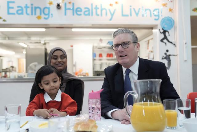 Britain's Prime Minister Keir Starmer (R) pays a visit to St Paul's Church of England Primary School in southeast London on March 23, 2026, to announce further cost-of-living support for parents through an expansion of the government's school-based nurseries. (Photo by Stefan Rousseau / POOL / AFP)