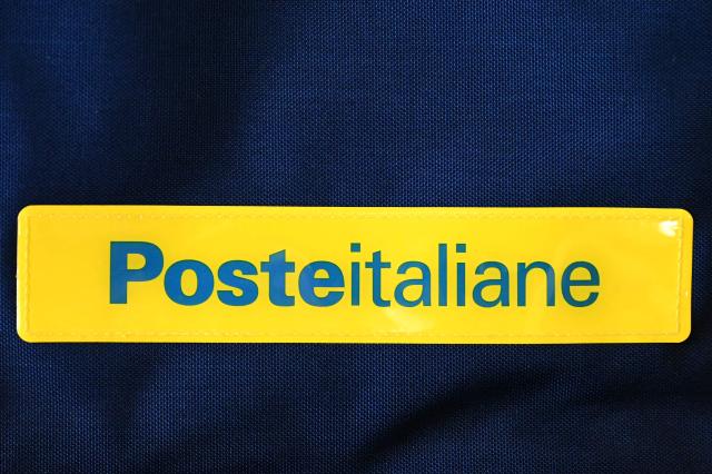 (FILES) A picture shows the logo of the Poste Italiane, the Italian postal service provider, on February 1, 2024 in Rome. Italy's state-controlled postal service is launching a 10.8-billion euro takeover bid for telecom operator TIM, in which it already holds a majority stake, the companies said on March 23, 2026. (Photo by Alberto PIZZOLI / AFP)