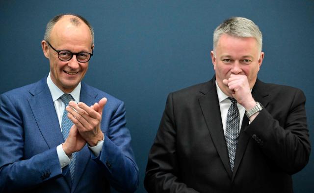German Chancellor Friedrich Merz (L) applauds Gordon Schnieder, the conservative CDU party's top candidate for state elections in the southwestern state of Rhineland-Palatinate, on March 23, 2026, one day after the vote, at the CDU's headquarters in Berlin. German Chancellor Friedrich Merz's conservatives ousted the centre-left Social Democratic Party in the closely watched state election in which the far right also made big gains, according to exit polls. (Photo by Tobias SCHWARZ / AFP)