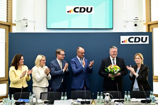 Gordon Schnieder (2ndR), the conservative CDU party's top candidate for state elections in the southwestern state of Rhineland-Palatinate, reacts as German Chancellor Friedrich Merz (C), treasurer of Germany's conservative Christian Democratic Union (CDU) Franziska Hoppermann, Deputy Secretary General of Germany's Christian Democratic Union (CDU) Christina Stumpp, Secretary General of Germany's Christian Democratic Union (CDU) Carsten Linnemann and board member of Germany's Christian Democratic Union (CDU) Karin Prien applaud on March 23, 2026, one day after the vote, at the CDU's headquarters in Berlin. German Chancellor Friedrich Merz's conservatives ousted the centre-left Social Democratic Party in the closely watched state election in which the far right also made big gains, according to exit polls. (Photo by Tobias SCHWARZ / AFP)