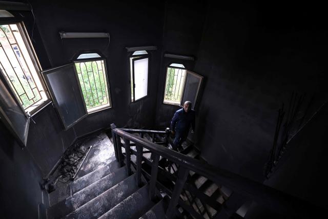 A Palestinian man inspects a burnt out home following a reported attack by Israeli settlers in the village of Deir al-Hatab, east of the city of Nablus, in the Israeli-occupied West Bank on March 23, 2026. Palestinian residents said on March 22, 2026, that Israeli settlers torched buildings and cars in attacks on several villages in the occupied West Bank, with Israel's army condemning "violence of any kind" after the fact.  Violence in the Palestinian West Bank, which Israel has occupied since 1967, has soared since the Hamas attack on Israel triggered the Gaza war in October 2023. (Photo by JAAFAR ASHTIYEH / AFP)