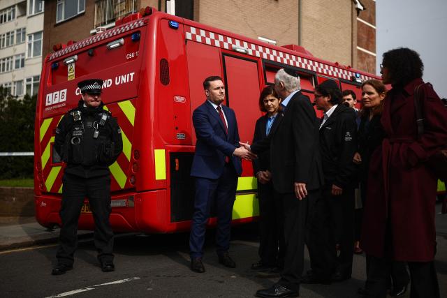 Britain's Health Secretary Wes Streeting (2nd L) meets with members of the local community in the Golders Green neighbourhood of north London on March 23, 2026, after volunteer ambulances run by a Jewish organisation were set on fire overnight. Britain's Prime Minister Keir Starmer on March 23 condemned "a deeply shocking antisemitic arson attack" on volunteer ambulances run by a Jewish organisation in London. (Photo by Henry Nicholls / AFP)