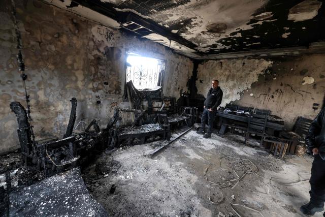 A Palestinian man inspects a burnt out home following a reported attack by Israeli settlers in the village of Deir al-Hatab, east of the city of Nablus, in the Israeli-occupied West Bank on March 23, 2026. Palestinian residents said on March 22, 2026, that Israeli settlers torched buildings and cars in attacks on several villages in the occupied West Bank, with Israel's army condemning "violence of any kind" after the fact.  Violence in the Palestinian West Bank, which Israel has occupied since 1967, has soared since the Hamas attack on Israel triggered the Gaza war in October 2023. (Photo by JAAFAR ASHTIYEH / AFP)