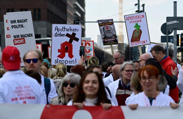 Protesters take part in a demonstration organised by the Federal Union of German Pharmacists' Associations (ABDA, Bundesvereinigung Deutscher Apothekerverbaende) on March 23, 2026 in Berlin. Pharmacists across the country staged a protest, closing their pharmacies and holding rallies to demand a pay rise. (Photo by Tobias SCHWARZ / AFP)