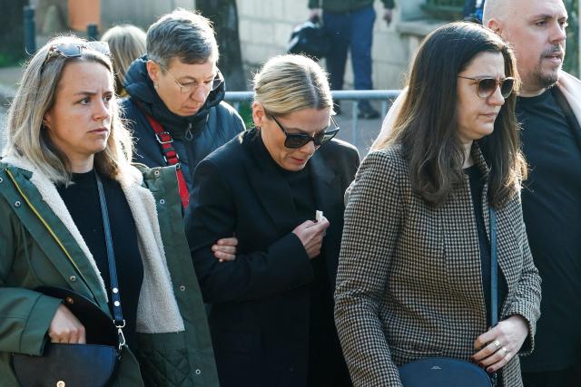 Audrey, the wife of late French actor and comedian Bruno Salomone (C) and relatives walk during the funeral of Bruno Salomone in Joinville-le-Pont on March 23, 2026. Bruno Salomone died on March 15, 2026, aged 55. (Photo by Kenzo TRIBOUILLARD / AFP)