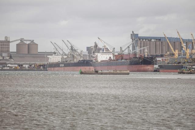 A general view of a cargo vessels and ships docked next to containers at the Durban Harbour in Durban on March 23, 2026. (Photo by RAJESH JANTILAL / AFP)
