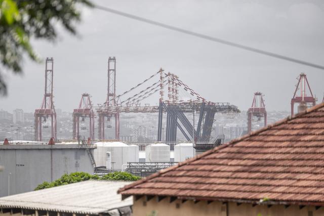 A general view from taken from a residential area, shows cranes and containers at the Durban Harbour in Durban on March 23, 2026. (Photo by RAJESH JANTILAL / AFP)