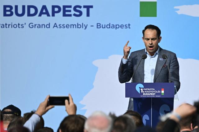 Belgian politician, leader of Vlaams Belang party Tom van Grieken addresses the audience during the first Patriotic Rally at the Millenaris Cultural Center in Budapest, Hungary, March 23, 2026, a key campaign event for the upcoming April elections. In the April 12, 2026 vote, Hungarian Prime Minister Viktor Orban is facing his toughest challenge since he returned to power in 2010, according to opinion polls, against a backdrop of a stagnating economy and growing discontent with public services, among other issues. (Photo by Attila KISBENEDEK / AFP)