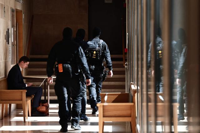 Members of the Regional Intervention and Security Teams (ERIS) patrol inside the courthouse on the opening day of the trial of members of the DZ Mafia drug trafficking organisation over a double murder committed in 2019, in Aix-en-Provence, southern France on March 23, 2026. (Photo by Thibaud MORITZ / AFP)
