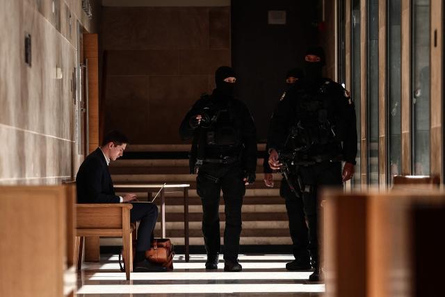 Members of the Regional Intervention and Security Teams (ERIS) patrol inside the courthouse on the opening day of the trial of members of the DZ Mafia drug trafficking organisation over a double murder committed in 2019, in Aix-en-Provence, southern France on March 23, 2026. (Photo by Thibaud MORITZ / AFP)