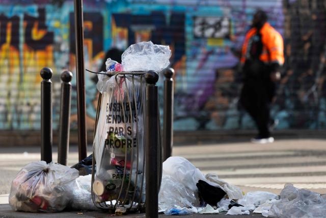 This photograph shows an overflowing public bin in Paris on March 23, 2026. (Photo by JOEL SAGET / AFP)