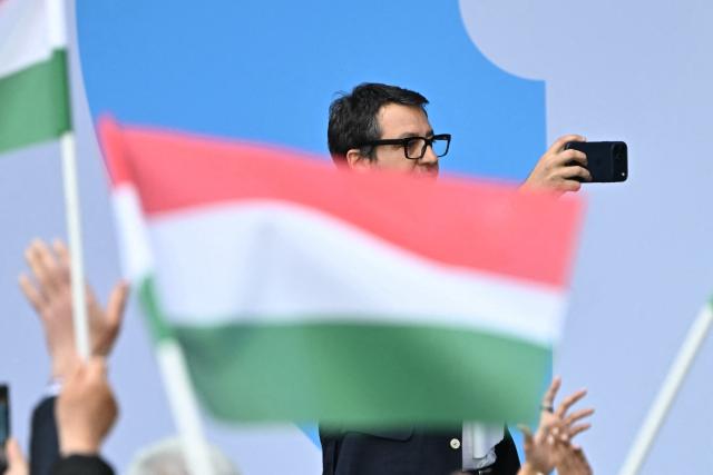 Italy's Infrastructure Minister and Deputy Prime Minister Matteo Salvini takes pictures of the audience as he arrives to address the audience during the first Patriotic Rally at the Millenaris Cultural Center in Budapest, Hungary, March 23, 2026, a key campaign event for the upcoming April elections. In the April 12, 2026 vote, Hungarian Prime Minister Viktor Orban is facing his toughest challenge since he returned to power in 2010, according to opinion polls, against a backdrop of a stagnating economy and growing discontent with public services, among other issues. (Photo by Attila KISBENEDEK / AFP)