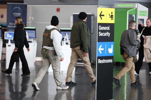 Federal law enforcement agents, including some with Immigration and Customs Enforcement (ICE), walk through  John F. Kennedy International Airport in New York, on March 23, 2026. Immigration agents will be deployed in US airports beginning Monday, aiming to alleviate soaring congestion at security screenings amid a weeks-long budget standoff over President Donald Trump's mass deportation drive, officials said. (Photo by CHARLY TRIBALLEAU / AFP)