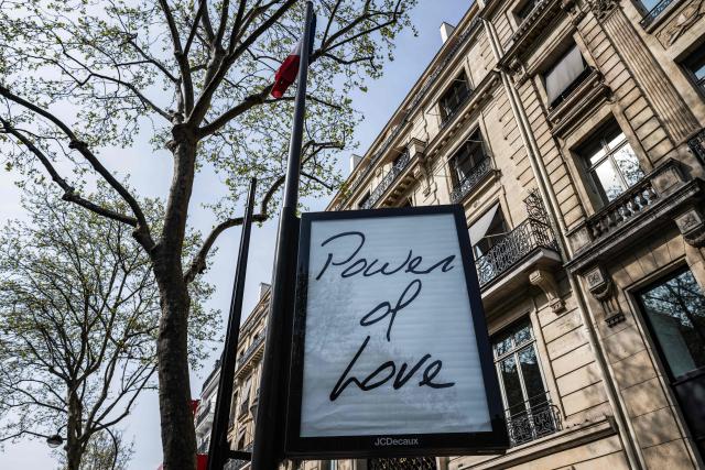 This photograph shows a billboard displaying the title of Canadian singer Celine Dion song "Power of Love" in central Paris on March 23, 2026. "Pour que tu m'aimes encore" or "My Heart Will Go On" can be read on mysterious posters in Paris, also featuring other iconic titles by Celine Dion and suggesting the big return of the Quebec diva for a series of concerts. (Photo by Blanca CRUZ / AFP)