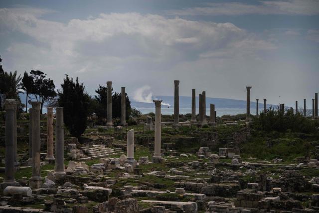 This photograph taken on March 23, 2026, shows smoke as it rises from the site of an Israeli air strike at the background of the archaeological site of the ruins of the Phoenician Port in the Southern Lebanese city of Tyre. The Lebanese president on March 22, 2026, slammed Israeli strikes on bridges and other infrastructure in the country's south, calling such attacks a "prelude to a ground invasion". Lebanon was drawn into the Middle East war on March 2, when pro-Iran Hezbollah launched rockets towards Israel in response to US-Israeli strikes that killed Iranian supreme leader on February 28, 2026. (Photo by Dimitar DILKOFF / AFP)