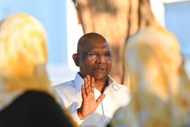 Abdulla Shahid, president of the Maldivian Democratic Party (MDP) and former president of the United Nations General Assembly (UNGA), speaks with residents during a public meeting urging voters to reject the proposed constitutional referendum to hold presidential and parliamentary elections simultaneously to reduce costs, at Thulhaadhoo in the Maldives' Baa Atoll Island on March 23, 2026. (Photo by Mohamed Afrah / AFP)