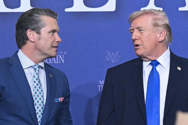 US President Donald Trump (R) speaks with US Secretary of Defense Pete Hegseth during the Memphis Safe Task Force roundtable in Memphis, Tennessee on March 23, 2026. (Photo by SAUL LOEB / AFP)
