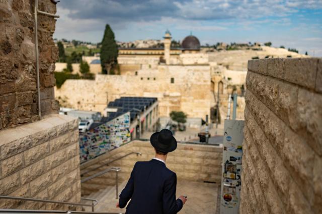 A Jewish man walks down stairs towards the Western Wall in Jerusalem's Old City on March 23, 2026. Since the United States and Israel unleashed strikes on Iran on February 28, war has spread across the Middle East, with casualties reported in countries across the region. (Photo by Odd ANDERSEN / AFP) / 