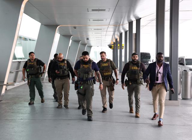 Federal law enforcement agents, including some with US Immigration and Customs Enforcement (ICE), walk outside LaGuardia Airport in New York, on March 23, 2026. Immigration agents will be deployed in US airports beginning Monday, aiming to alleviate soaring congestion at security screenings amid a weeks-long budget standoff over President Donald Trump's mass deportation drive, officials said. (Photo by TIMOTHY A.CLARY / AFP)