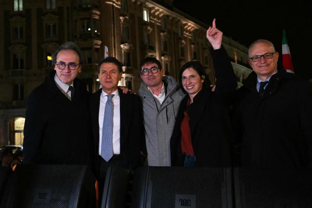 From left : Angelo Bonelli, spokesperson of green party Europa Verde, Giuseppe Conte, president of the Five Star Movement (M5S), Nicola Fratoianni, member of the Chamber of Deputies of Italy, Elly Schlein, Secretary of Italian Democratic Party (PD), and Roberto Gualtieri, Rome's mayor pose together as supporters of the "No" to the Constitutional referendum on Justice reform celebrate their victory at Piazza Barberini in Rome on March 23, 2026. Italians voted against a referendum on justice proposed by Prime Minister Giorgia Meloni, in what would be a major blow for the far-right leader. With the ballots from more than a quarter of polling stations counted, the "No" vote in the constitutional referendum was ahead with more than 54 percent. (Photo by Andreas SOLARO / AFP)