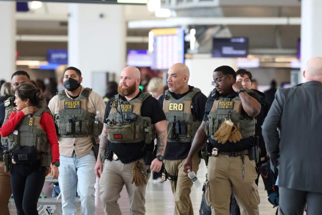 US Immigration and Customs Enforcement (ICE) agents walk through LaGuardia Airport in New York, on March 23, 2026. Immigration agents will be deployed in US airports beginning Monday, aiming to alleviate soaring congestion at security screenings amid a weeks-long budget standoff over President Donald Trump's mass deportation drive, officials said. (Photo by TIMOTHY A. CLARY / AFP)