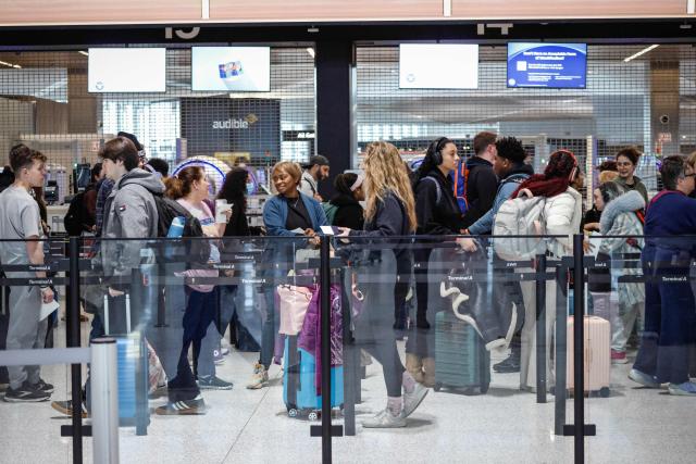 Passengers wait in line inside Newark Liberty International Airport in Newark, New Jersey, on March 23, 2026. Immigration agents will be deployed in US airports beginning Monday, aiming to alleviate soaring congestion at security screenings amid a weeks-long budget standoff over President Donald Trump's mass deportation drive, officials said. (Photo by kena betancur / AFP)