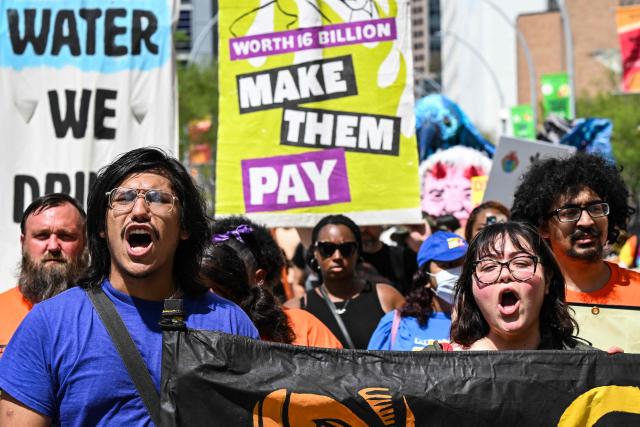 Demonstrators shout slogans while protesting against the 2026 CERAWeek by S&P Global energy conference in Houston, Texas on March 23, 2026.  (Photo by RONALDO SCHEMIDT / AFP)