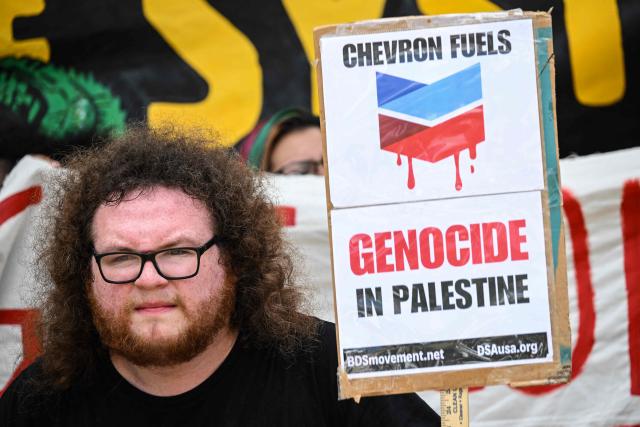 Demonstrators march to protest against the 2026 CERAWeek by S&P Global energy conference in Houston, Texas on March 23, 2026.  (Photo by RONALDO SCHEMIDT / AFP)