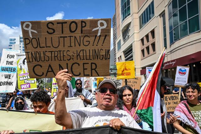 Demonstrators march to protest against the 2026 CERAWeek by S&P Global energy conference in Houston, Texas on March 23, 2026.  (Photo by RONALDO SCHEMIDT / AFP)