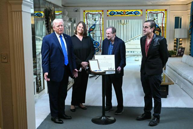 US President Donald Trump (L) speaks as he stands to the Medal of Freedom that he awarded postumously to Elvis Presely in 2018 as he visits Graceland, the estate of Elvis Presley, in Memphis, Tennessee on March 23, 2026. (Photo by SAUL LOEB / AFP)