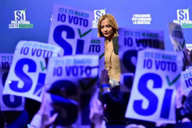 (FILES) Italy's Prime Minister Giorgia Meloni greets supporters at the end of a campaign meeting of Italian right wing party Brothers of Italy (Fratelli d'Italia) (Fdi) to support the "Yes" to Justice referendum, in Milan on March 12, 2026. Italian Prime Minister Giorgia Meloni on March 23, 2026 conceded defeat in a referendum on her justice reforms, while confirming she would not hand in her resignation. (Photo by Stefano RELLANDINI / AFP)