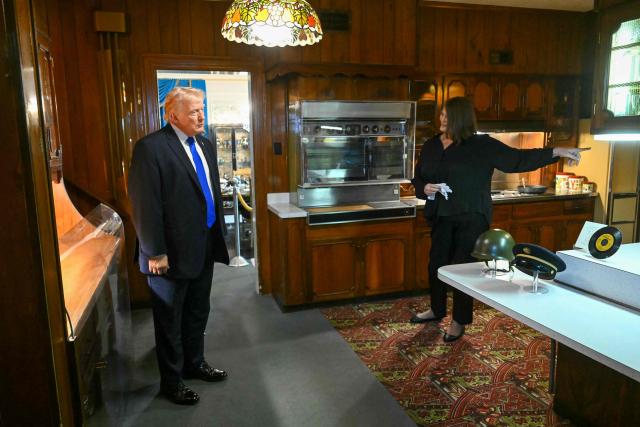 US President Donald Trump tours the kitchen of Graceland, the estate of Elvis Presley, accompanied by Angie Marchese, vice president of Graceland's Archives and Exhibits, in Memphis, Tennessee on March 23, 2026. (Photo by SAUL LOEB / AFP)