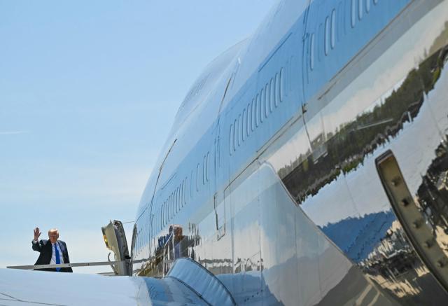 US President Donald Trump waves as he boards Air Force One at Memphis International Aiport in Memphis, Tennessee, on March 23, 2026. Trump was in Memphis to participate in the Memphis Safe Task Force Roundtable. (Photo by SAUL LOEB / AFP)