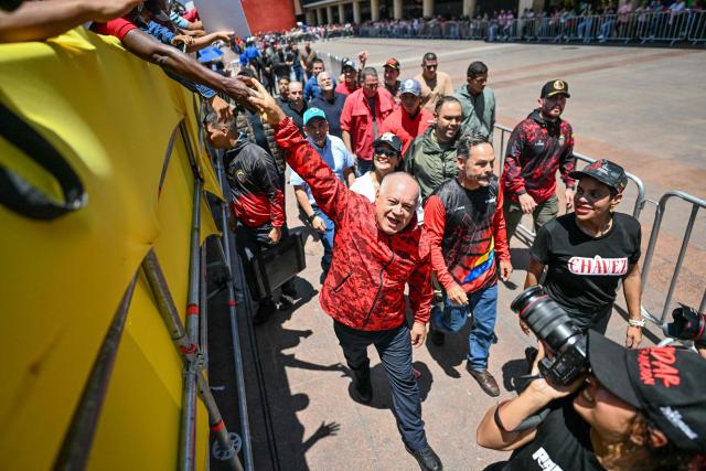 Venezuela's Minister of Interior, Justice and Peace Diosdado Cabello greets supporters as he takes part in a march demanding the complete lifting of US sanctions in Caracas on March 23, 2026. (Photo by Juan BARRETO / AFP)