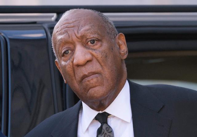 (FILES) US actor Bill Cosby pauses to listen to a heckler, as he arrives at the Montgomery County Courthouse March 6, 2018 in Norristown, Pennsylvania. A woman who said she was drugged and sexually assaulted by veteran US entertainer Bill Cosby was awarded more than $19 million on March 23, 2026 after a civil hearing in California. Donna Motsinger said she was working as a waitress more than 50 years ago when the performer began to target her. (Photo by Don EMMERT / AFP)