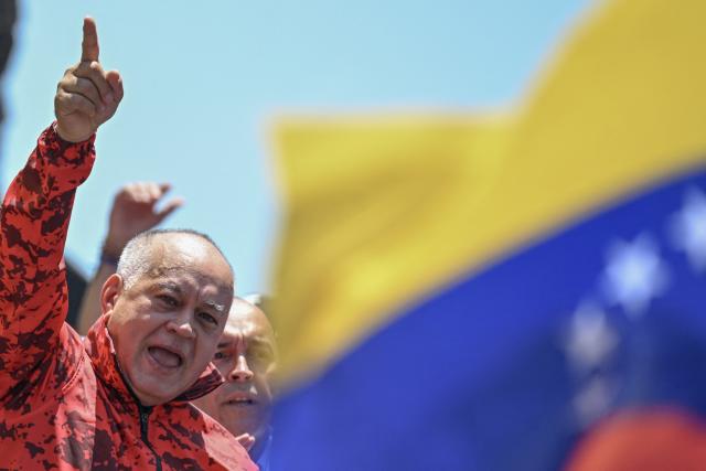 Venezuela's Minister of Interior, Justice, and Peace Diosdado Cabello gestures during a march demanding the complete lifting of US sanctions in Caracas on March 23, 2026. (Photo by Juan BARRETO / AFP)
