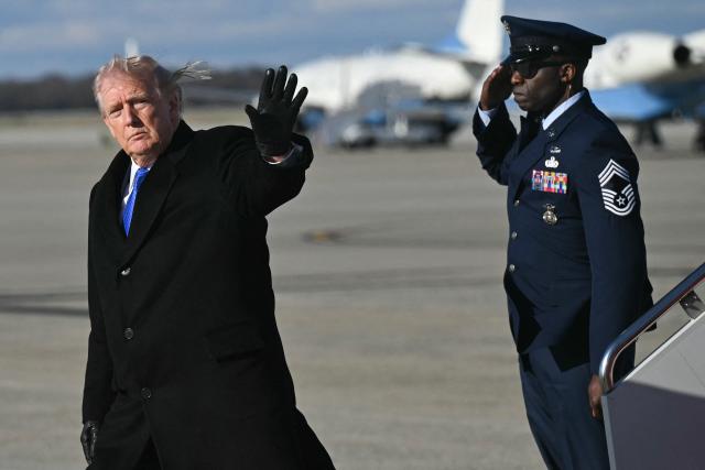 US President Donald Trump waves after disembarking from Air Force One upon arrival at Joint Base Andrews in Maryland, March 23, 2026. Trump is returning to the White House after participating in the Memphis Safe Task Force Roundtable. (Photo by SAUL LOEB / AFP)