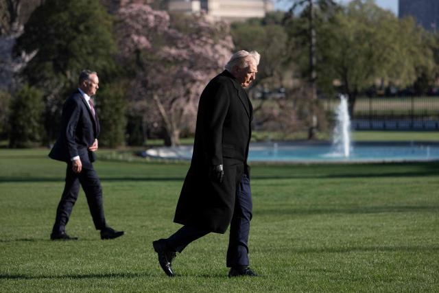 US President Donald Trump walks on the South Lawn upon arrival at the White House in Washington, DC, on March 23, 2026. (Photo by Jim WATSON / AFP)