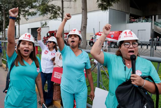 Supporters of Peru's presidential candidate Alfonso López Chau, from the Ahora Nacion party, shout slogans outside the Lima Convention Center before the first round of debates on tackling crime and corruption in Lima on March 23, 2026, ahead of the April 12 general election. (Photo by Connie FRANCE / AFP)