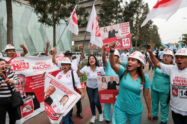 Supporters of Peru's presidential candidate Alfonso López Chau, from the Ahora Nacion party, shout slogans outside the Lima Convention Center before the first round of debates on tackling crime and corruption in Lima on March 23, 2026, ahead of the April 12 general election. (Photo by Connie FRANCE / AFP)