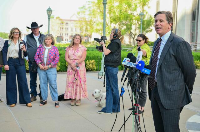 Parents watch as plaintiffs' attorney Mark Lanier speaks to the media outside Los Angeles Superior Court at the US Court House as the jury continue deliberations in the social media trial tasked to determine whether social media giants deliberately designed their platforms to be addictive to children, in Los Angeles, on March 23, 2026. The jurors in a landmark social media trial signaled March 23 that they could not reach a consensus against one of the two defendants, Meta and YouTube. "The jury has difficulty coming to a consensus regarding one defendant, do you have any advice on how to move forward?" the jurors told Judge Carolyn Kuhl, according to a note she read out loud. (Photo by Frederic J. Brown / AFP)