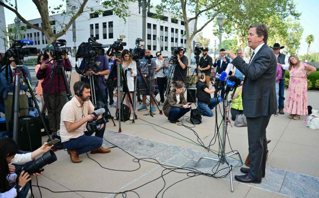 Parents watch as plaintiffs' attorney Mark Lanier speaks to the media outside Los Angeles Superior Court at the US Court House as the jury continue deliberations in the social media trial tasked to determine whether social media giants deliberately designed their platforms to be addictive to children, in Los Angeles, on March 23, 2026. The jurors in a landmark social media trial signaled March 23 that they could not reach a consensus against one of the two defendants, Meta and YouTube. "The jury has difficulty coming to a consensus regarding one defendant, do you have any advice on how to move forward?" the jurors told Judge Carolyn Kuhl, according to a note she read out loud. (Photo by Frederic J. Brown / AFP)